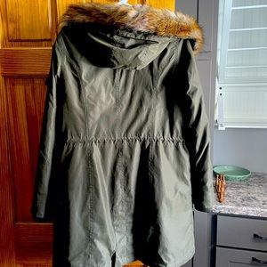 Women’s size medium winter coat. Dark olive green color with fur trim.